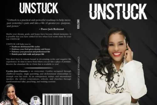 Elegant setup of floral teacup with macarons on a stack of vintage books.